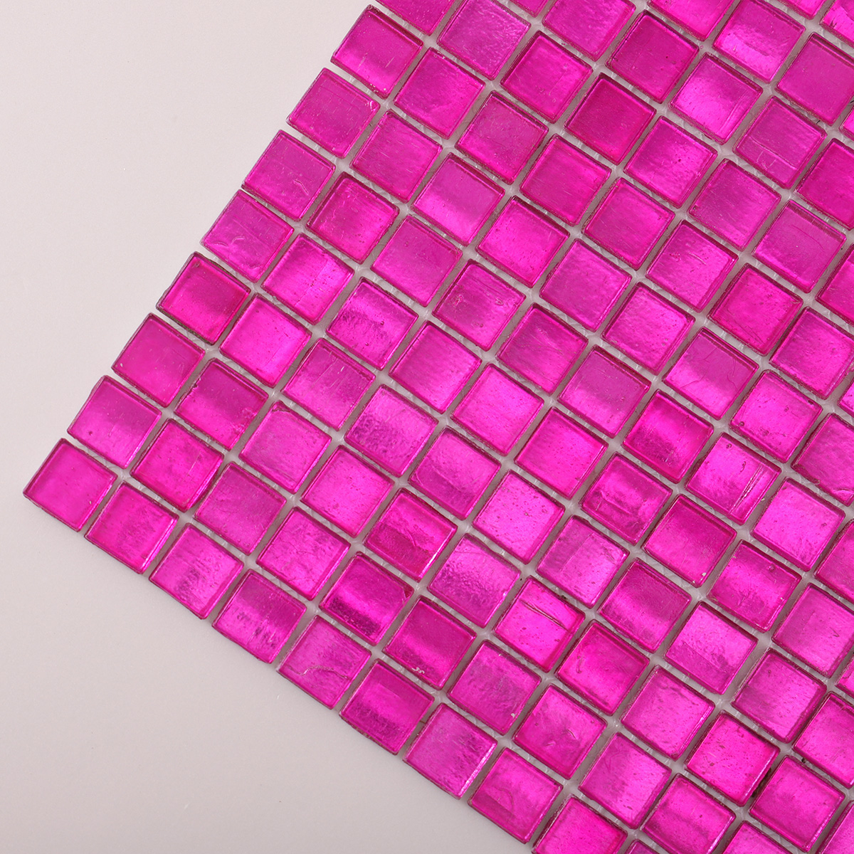 Detailed close-up of hot pink foil square glass mosaic tiles.
