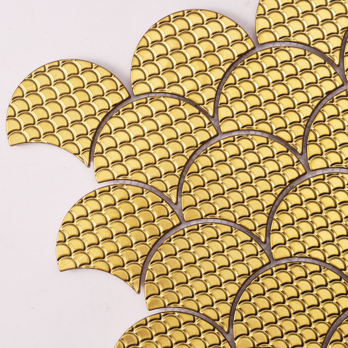 Close-up of 3D gold metal shell shaped mosaic tiles