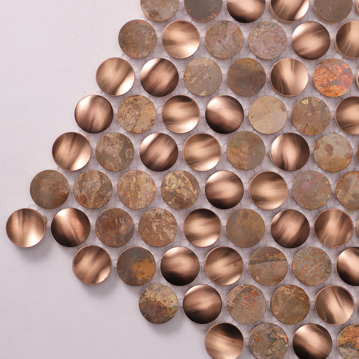 Detailed close-up of penny rounds stainless steel and copper mosaic tiles.