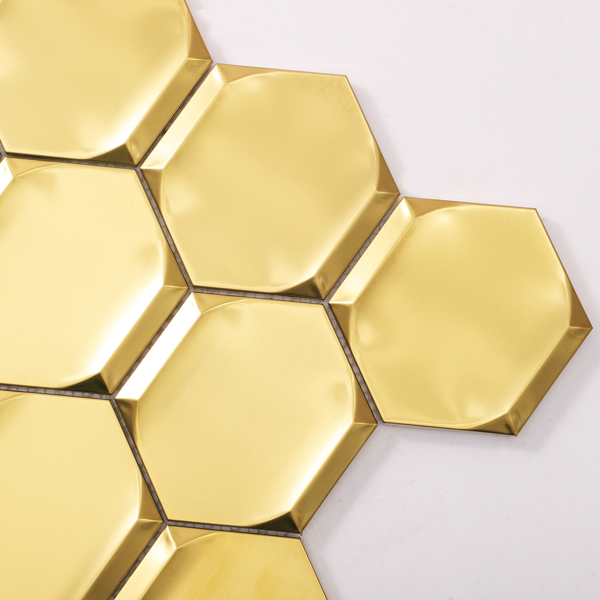 Detailed close-up of big hexagon gold 3D stainless steel metal mosaic tiles.