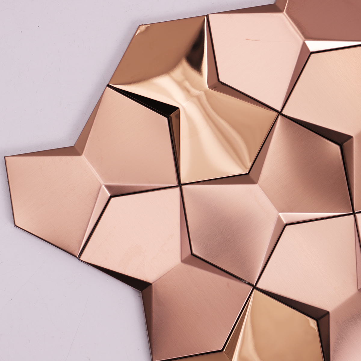 Close-up of rose gold 3D metal mosaic tiles.