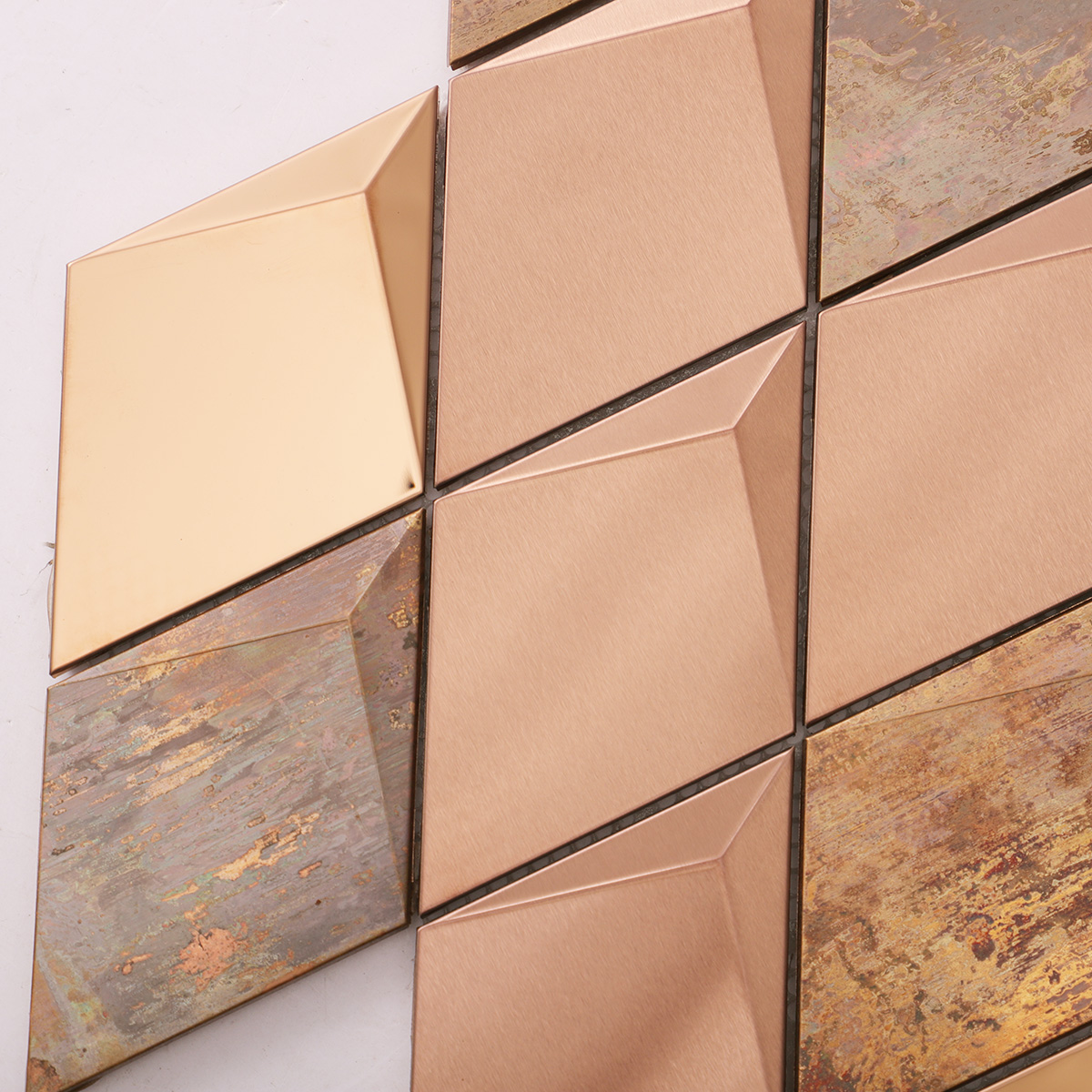 Close-up of 3D diamond stainless steel and copper mosaic tiles.