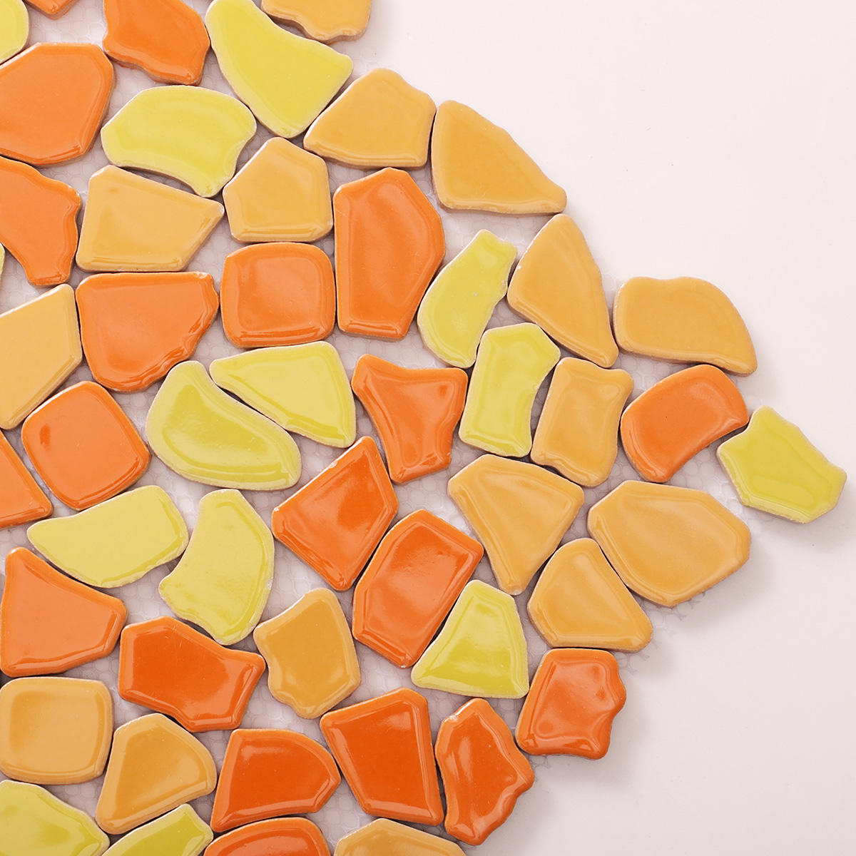 Detailed close-up of glazed broken ceramic mosaic porcelain tile.