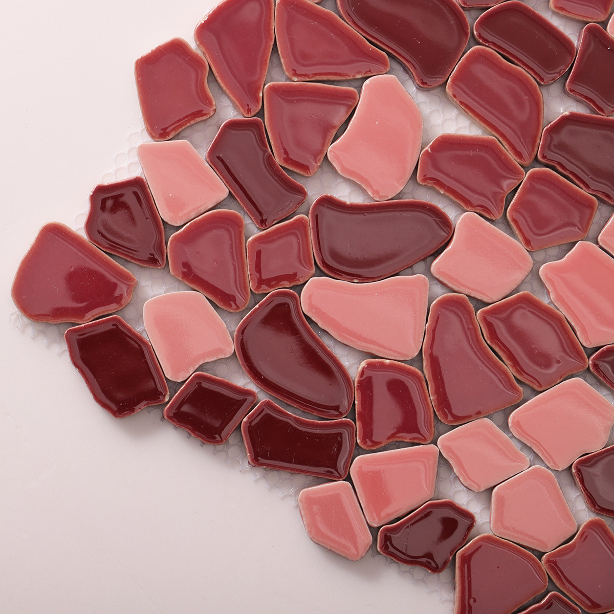 Detailed close-up of burgundy cracked ceramic mosaic tiles.