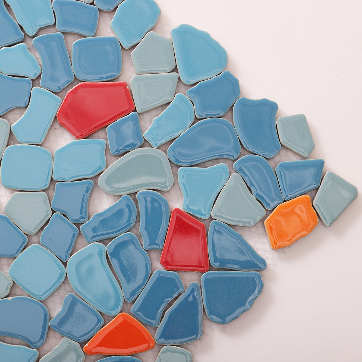 Detailed close-up of irregular ceramic pebble cracked mosaic tiles.