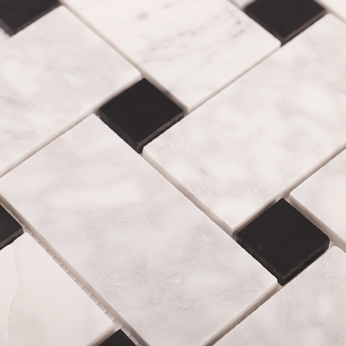 Close-up view of Carrara white basketweave marble mosaic tiles