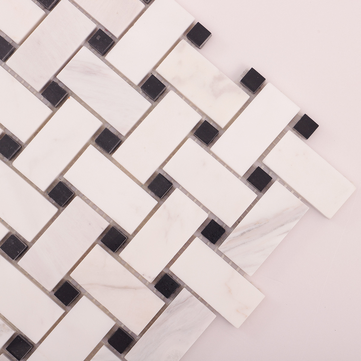 Close-up view of white basketweave marble mosaic tiles