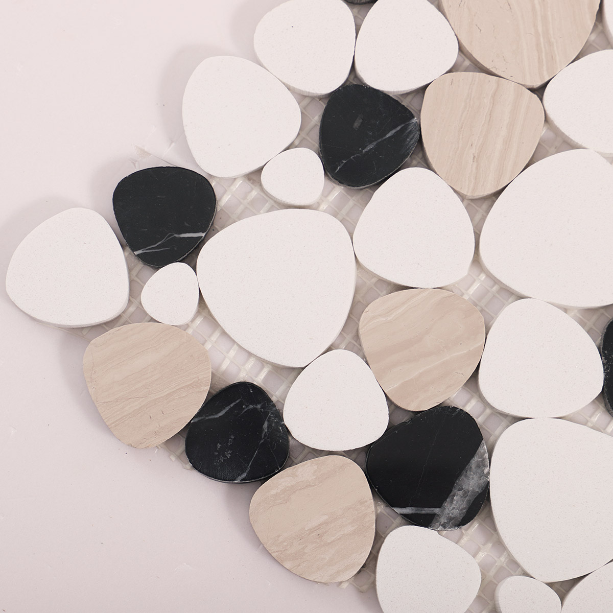 Close-up of white and black flat pebble stone mosaic tiles