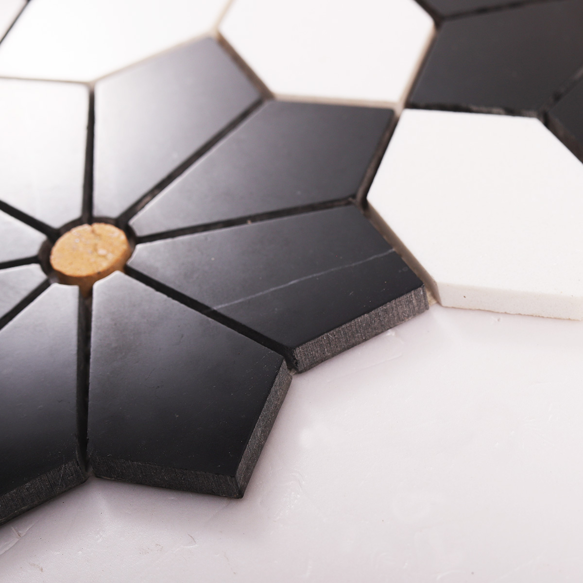 Side detail view of white and black floral marble mosaic tiles