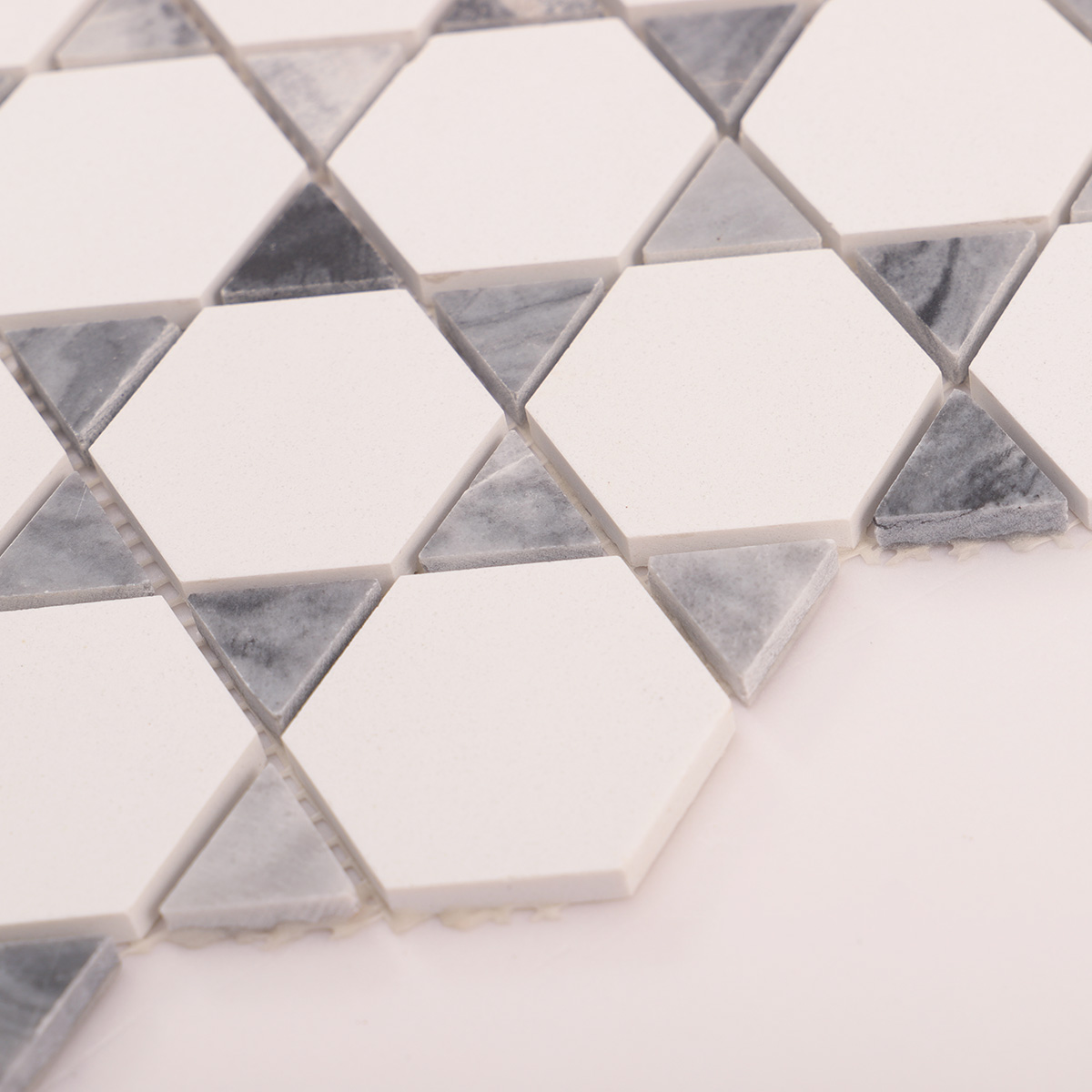 Side close-up view of hexagon mix triangle marble mosaic tiles, showing texture and thickness.