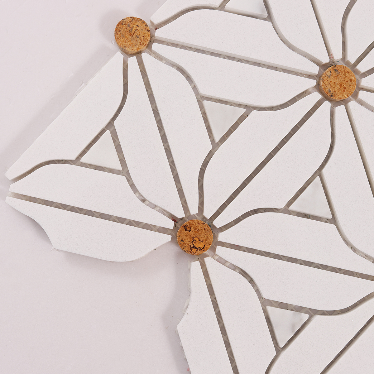 Detailed close-up of white floral marble mosaic tiles.