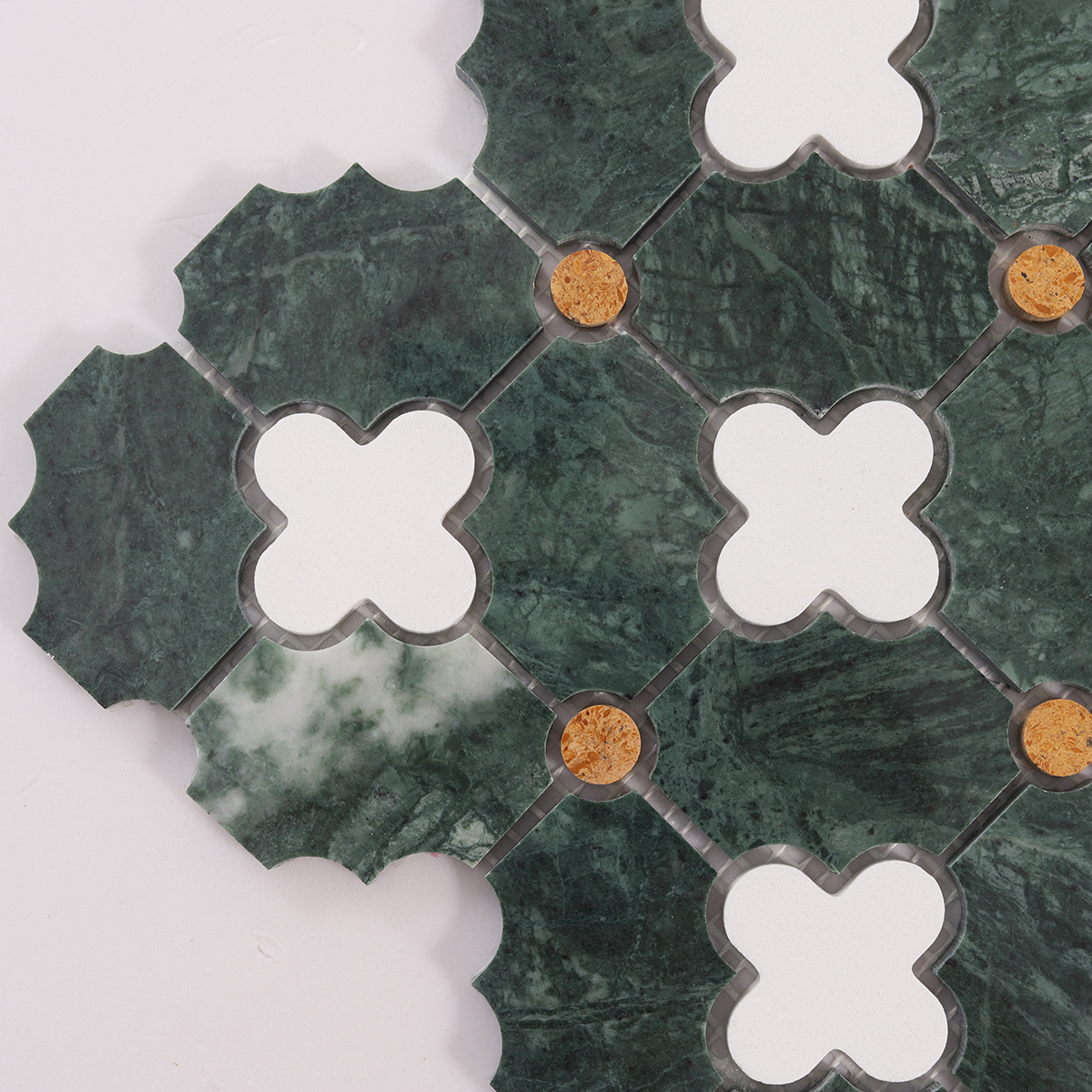 Close-up of green and white floral pattern polished stone mosaic tiles