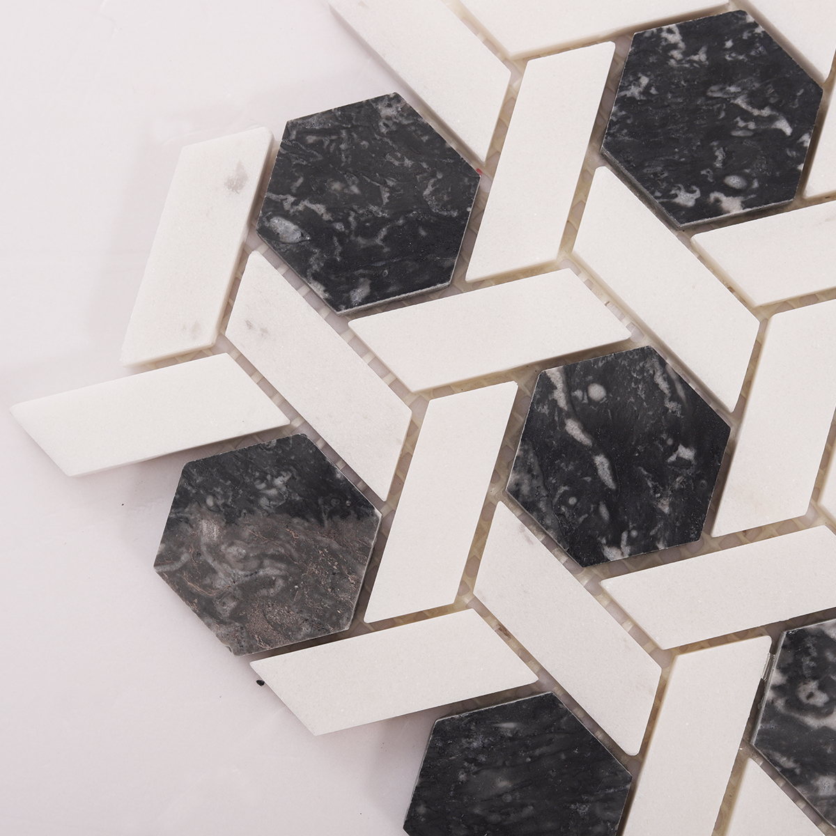 Detailed close-up of gray and white hexagonal lattice marble mosaic tiles