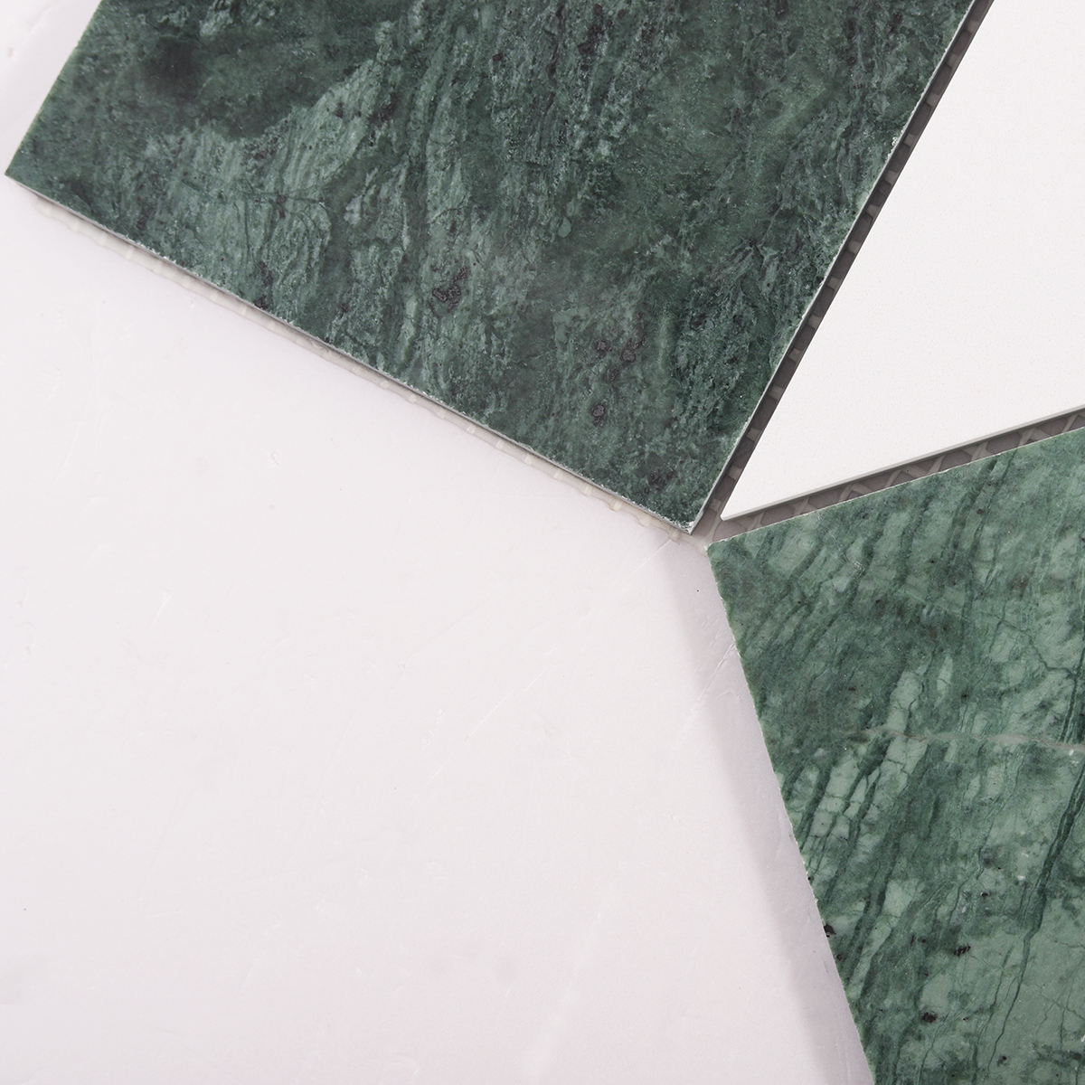 Detailed close-up of big hexagon green and white marble tiles