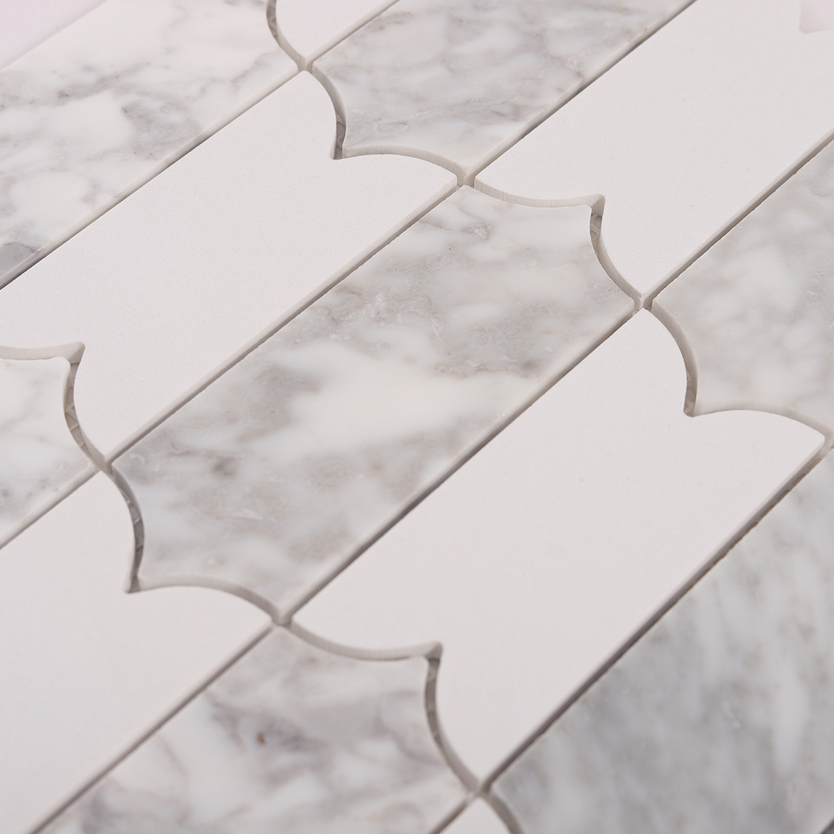 Close-up of Carrara white natural stone mosaic tiles