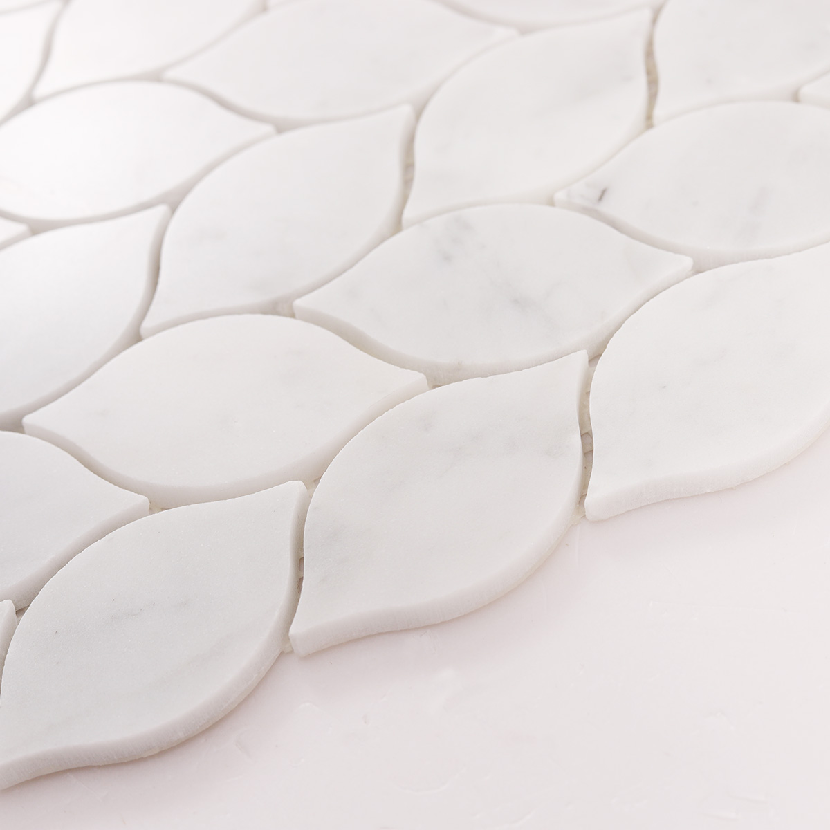 Side close-up view of Carrara white leaf marble mosaic tiles, showing texture and thickness