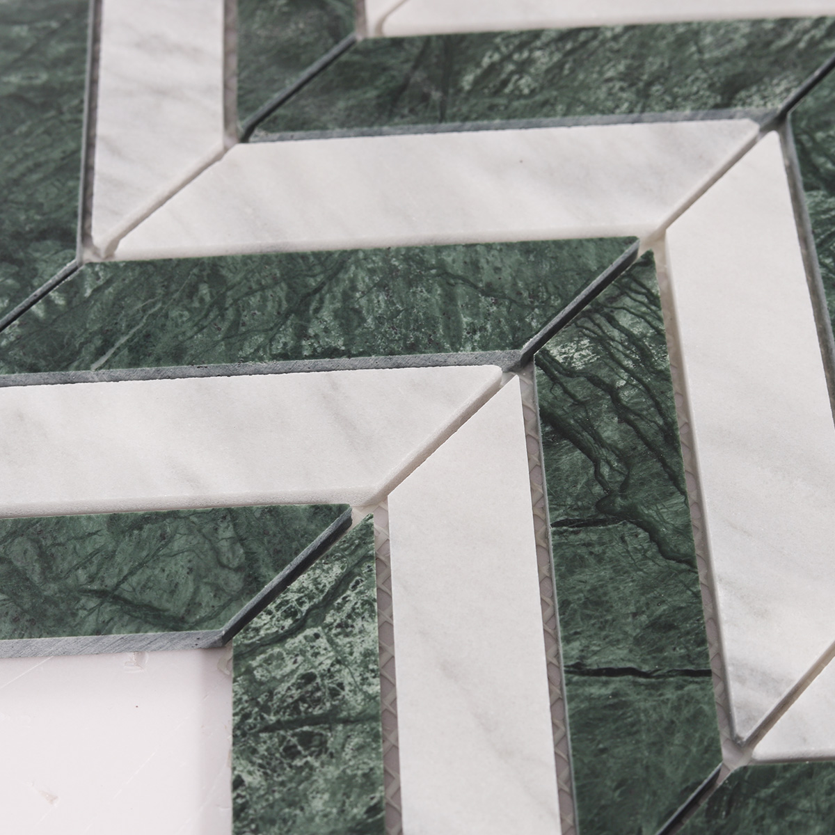 Detailed close-up of Green & White Herringbone Honed marble mosaic tiles.