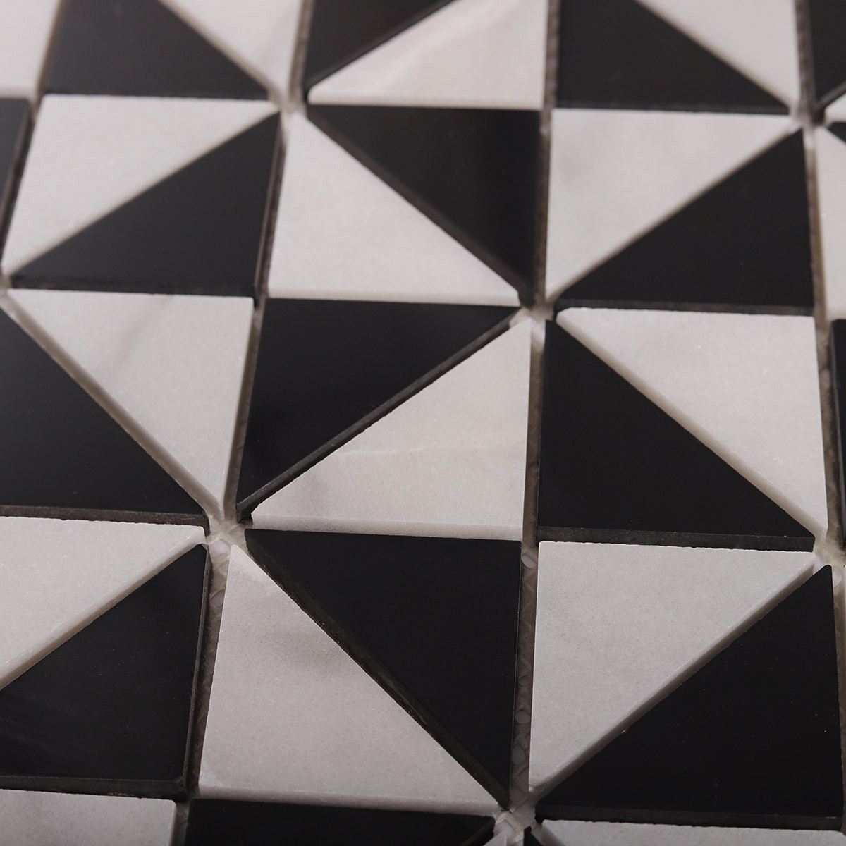 Detailed close-up of Carrara White and Black Triangle Windmill marble mosaic tiles