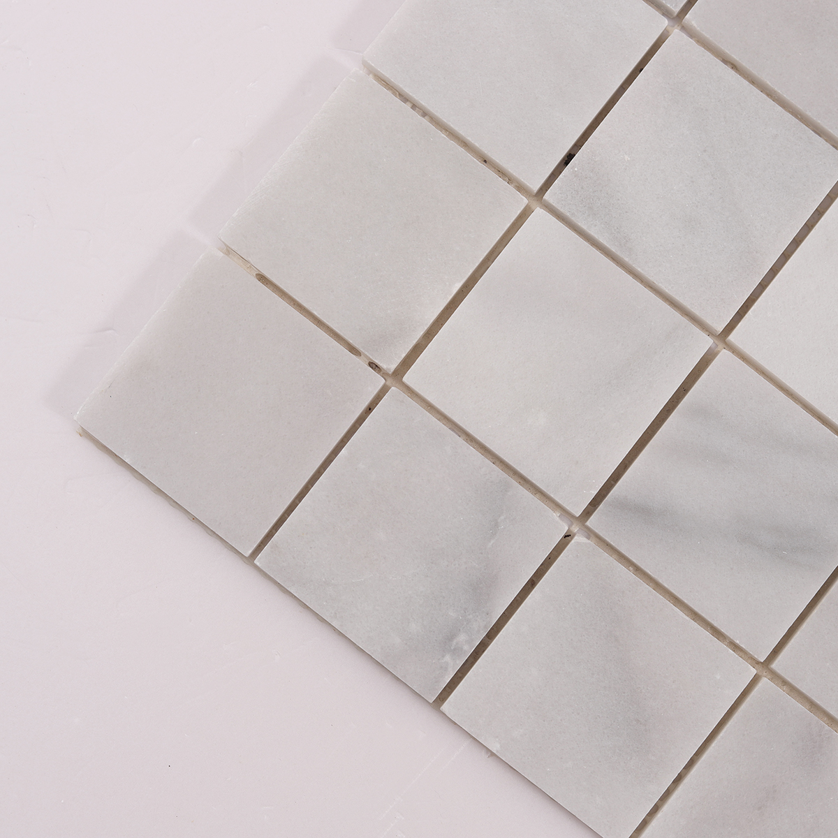Close-up of Carrara Venato Square Marble Mosaic Tiles