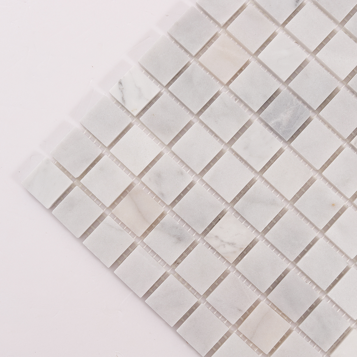 Detailed close-up of Carrara Venato Square Honed Marble Mosaic Tiles.