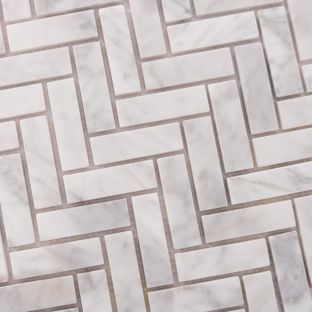 Close-up of Carrara White Herringbone Marble Polished Mosaic Tiles, texture detail