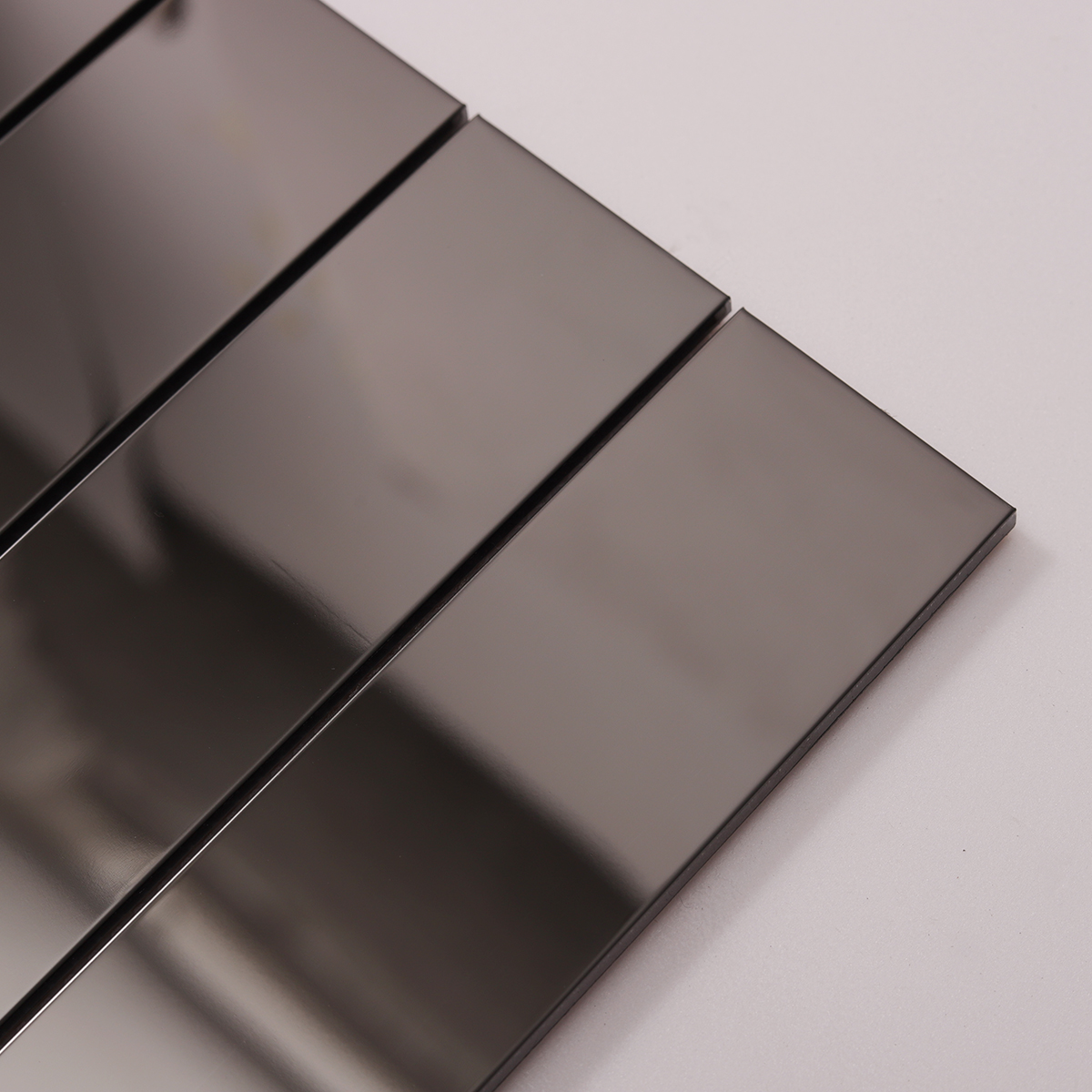 Detailed view of Black Glossy Stainless Steel Brick Mosaic Tile, showing reflective surface