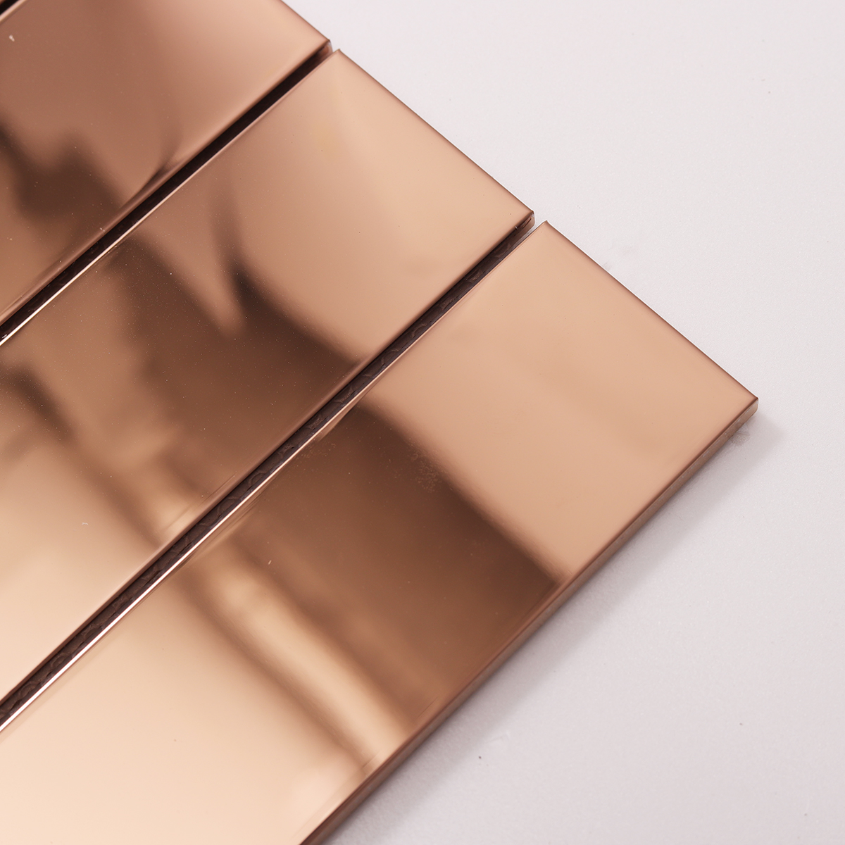 Close-up of Metal Rose Gold Glossy Stacked Mosaic Tile, texture detail