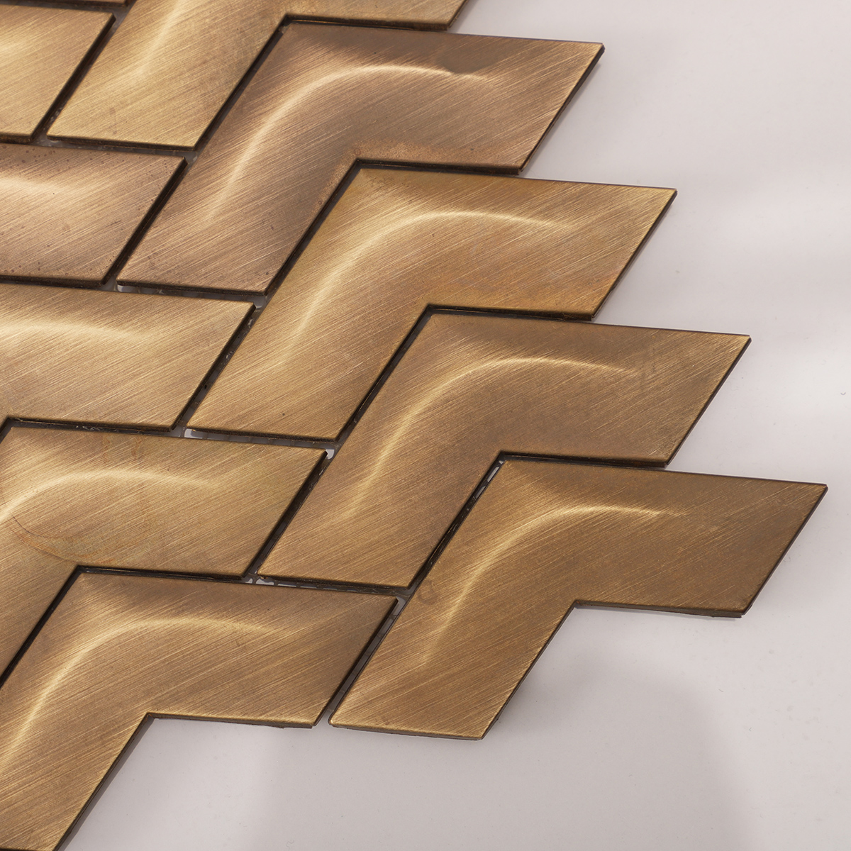 Close-up of Chevron Brass Metal Mosaic Wall Tile, showing intricate brass texture