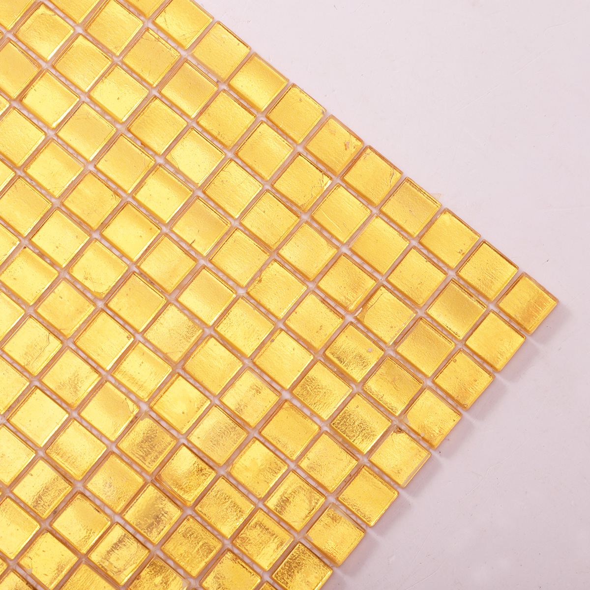 Close-up of Glossy Gold Square Glass Mosaic Tile, showing reflective surface and texture