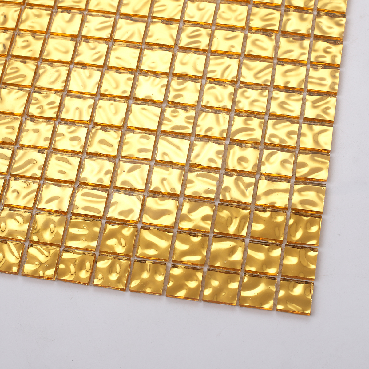 Close-up of Glossy Gold Glass Uniform Square Mosaic Wall Tile, showing glossy texture