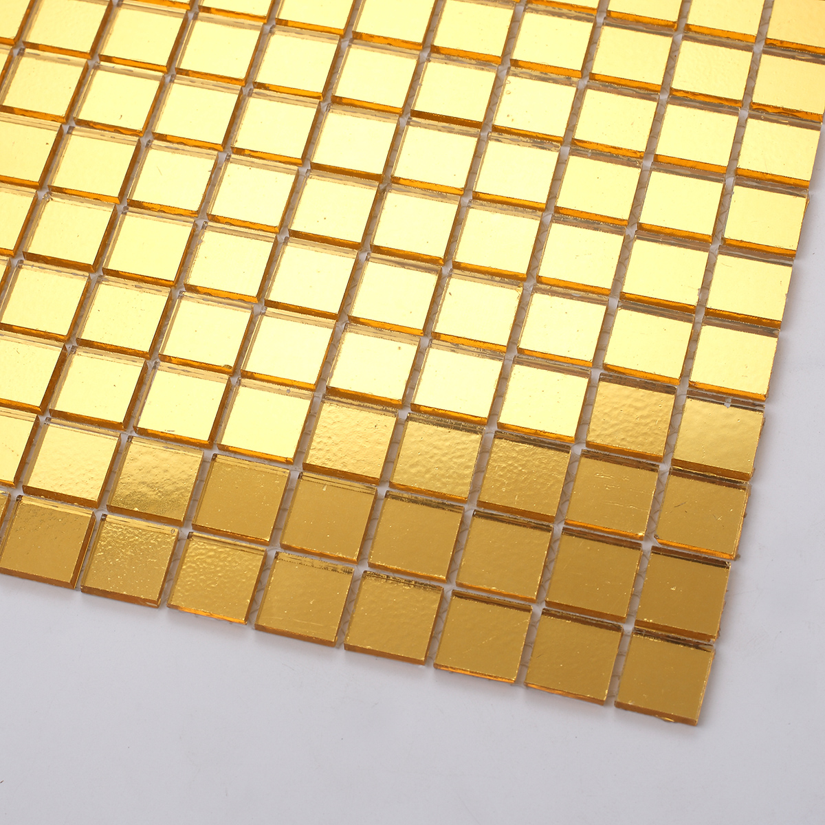 Close-up of Golden Mirror Glass Square Mosaic Tiles, showing mirror effect and smooth texture