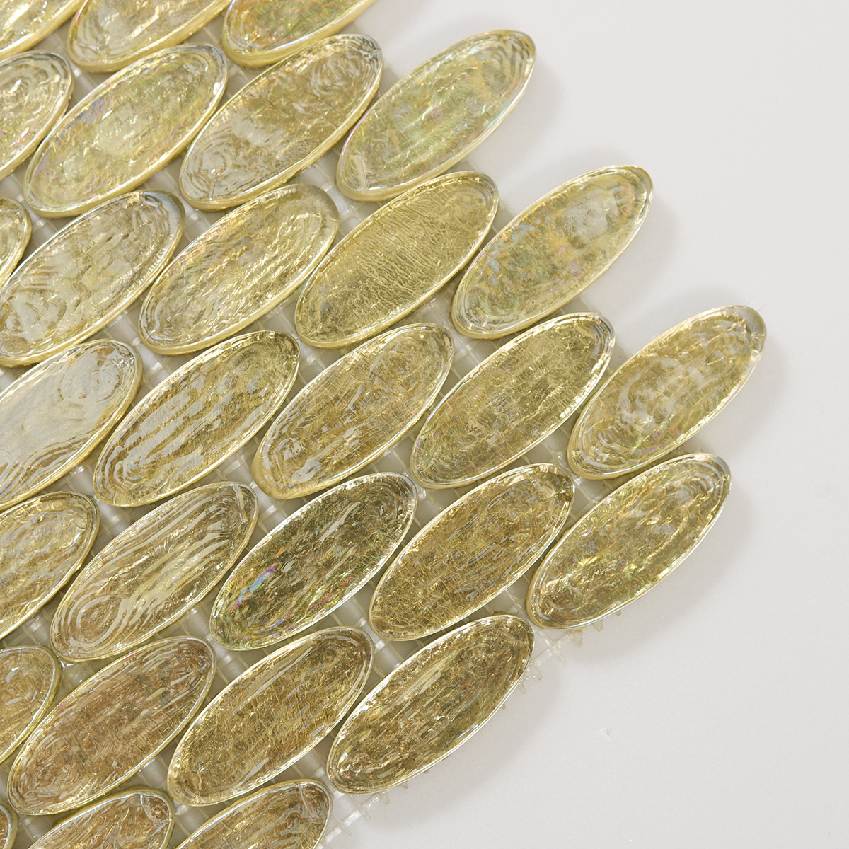 Detailed view of Gold Foil Oval Glass Mosaic Tile, showcasing smooth, glossy surface