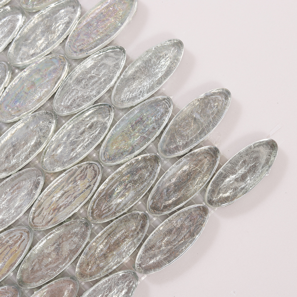 Close-up of Oval Silver Iridescent Glass Mosaic Tiles, showcasing smooth, reflective surface