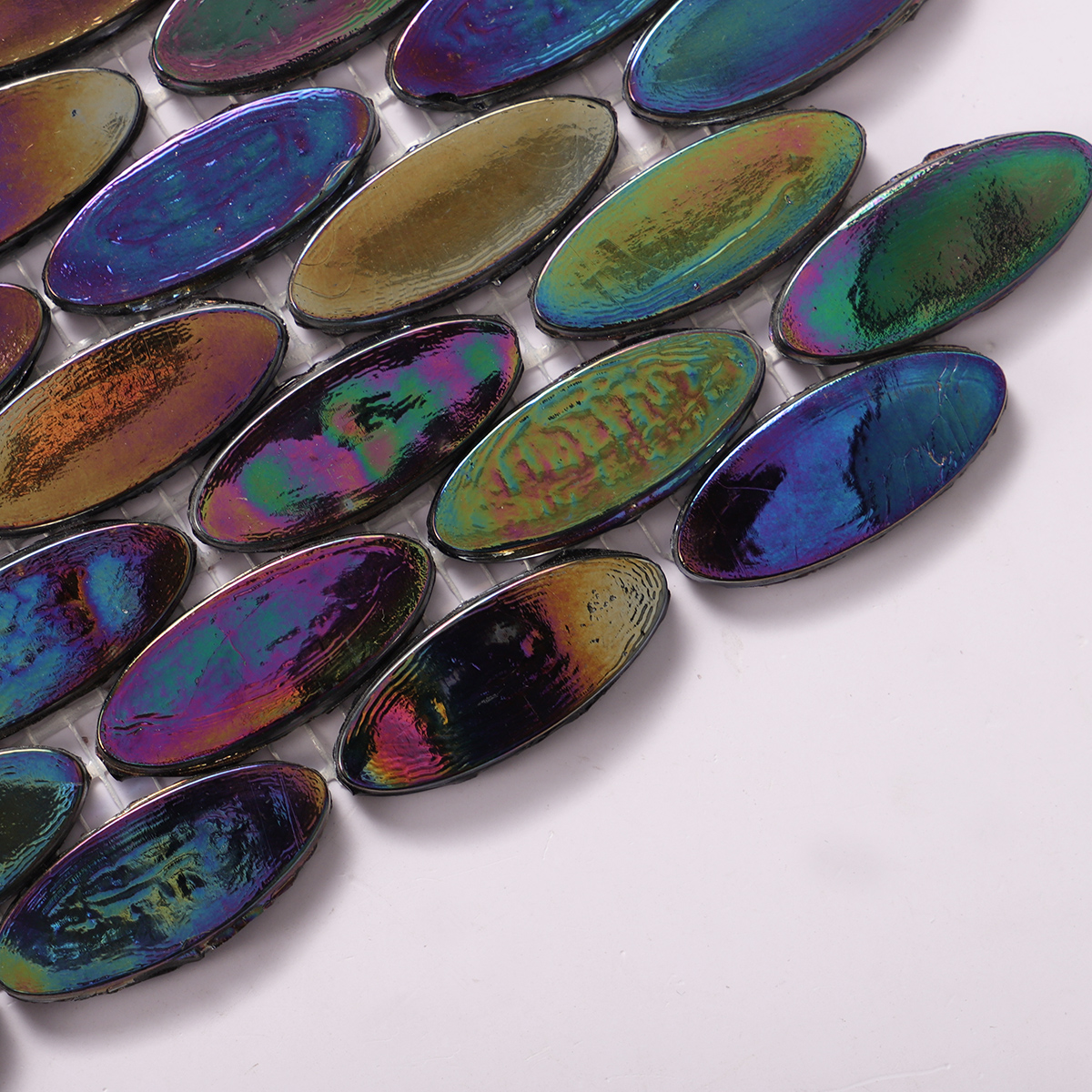 Side view close-up of Oval Iridescent Black Glass Mosaic Floor Tile, clean edges visible