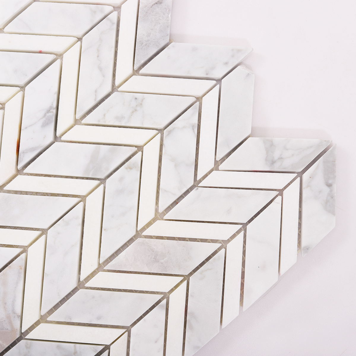 Close-up of Carrara White Marble Herringbone Mosaic Tile Pattern