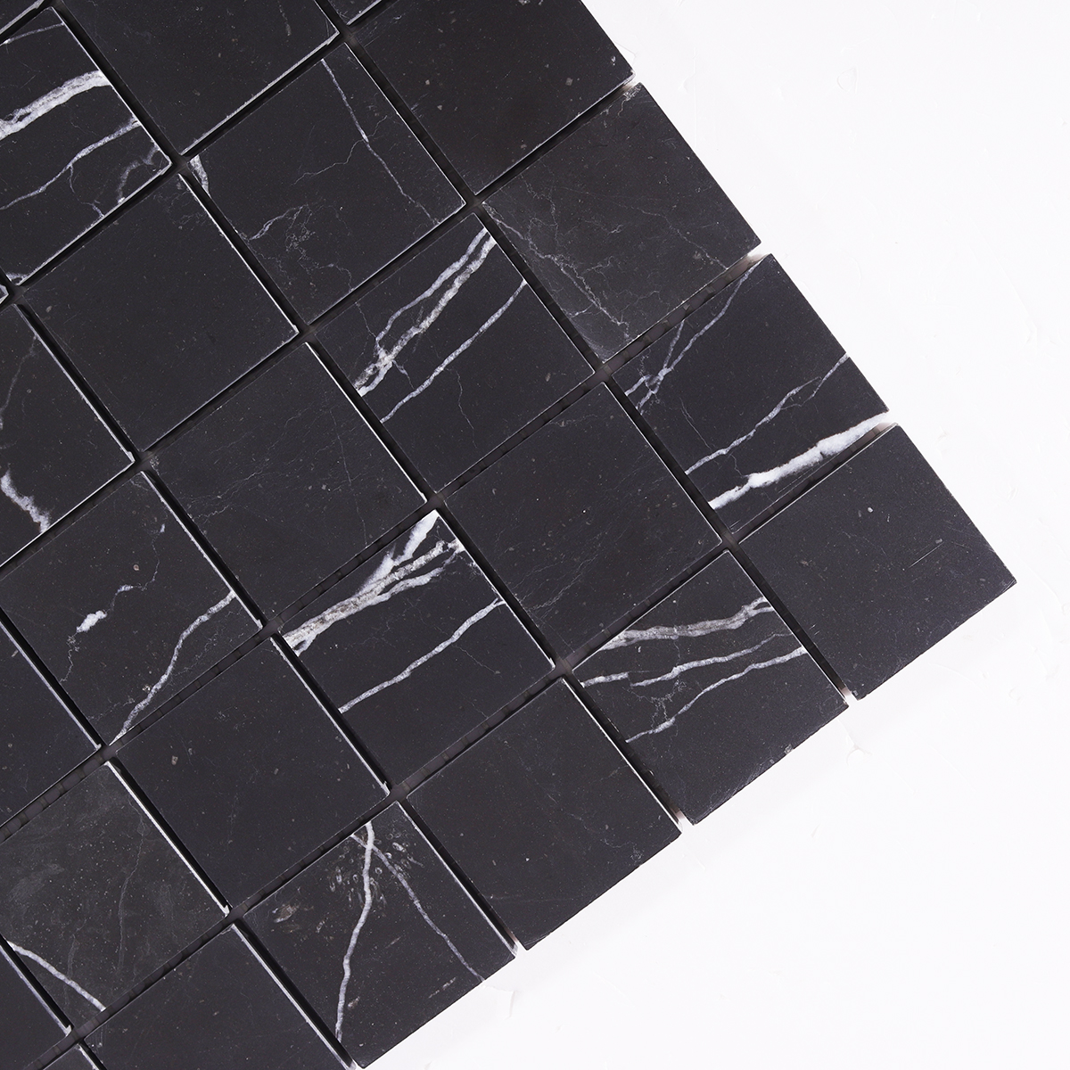 Detailed view highlighting the striking black marble texture of Nero Marquina tiles