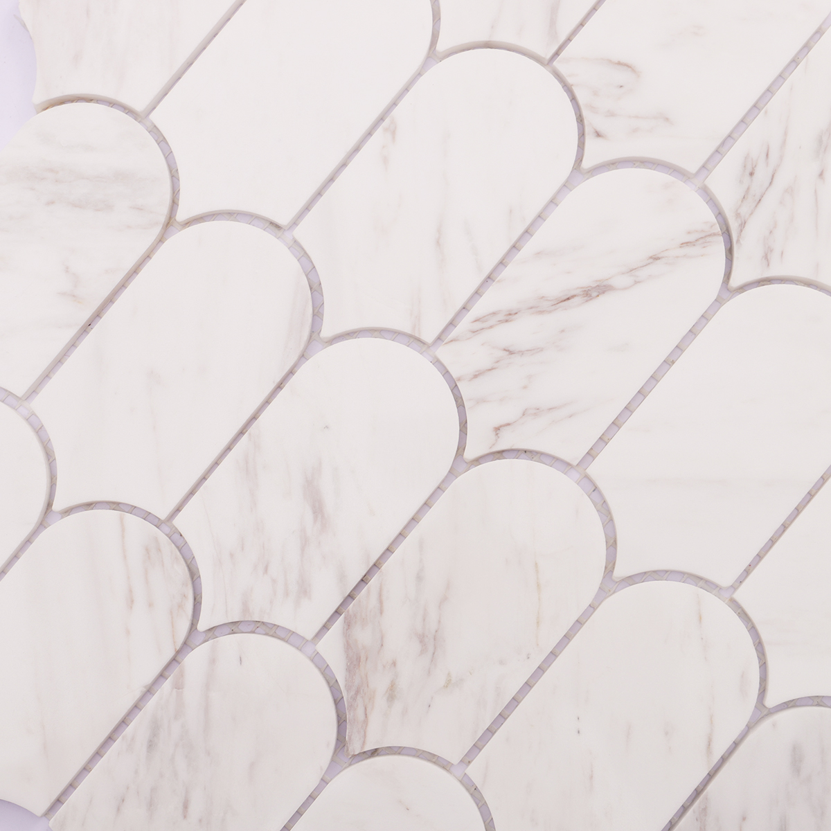 Close-up of white marble mosaic tile, showing light veins and smooth surface