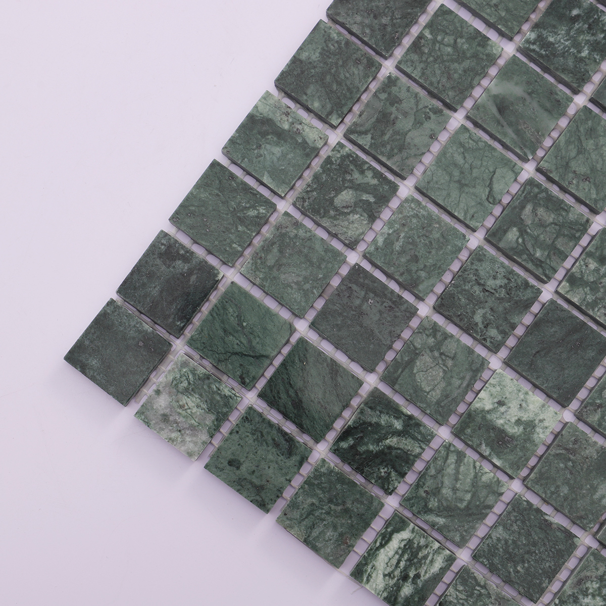 Close-up of green marble square mosaic tiles showcasing detailed marble veining and colors