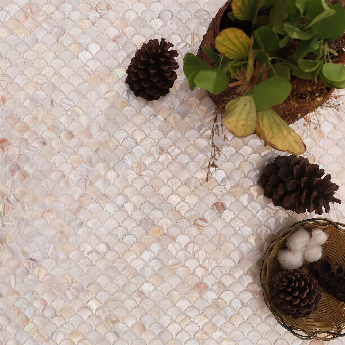 Mini fish scale beige mother of pearl mosaic tiles covering the surface in an elegant pattern.