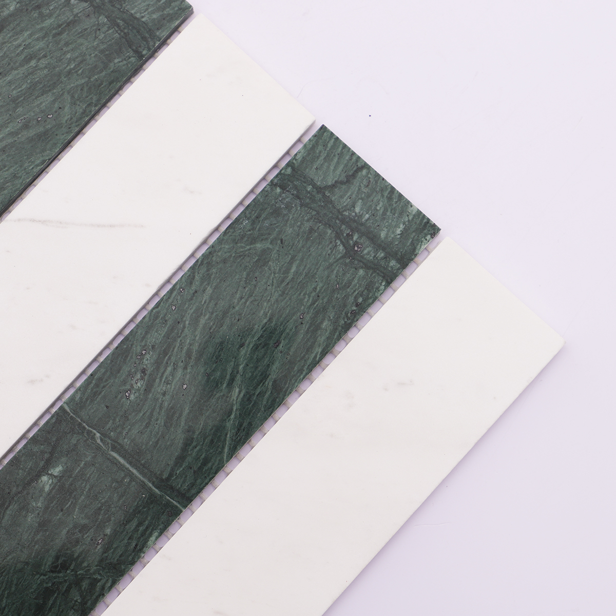 Detailed view of the smooth edges of the green and white marble strips