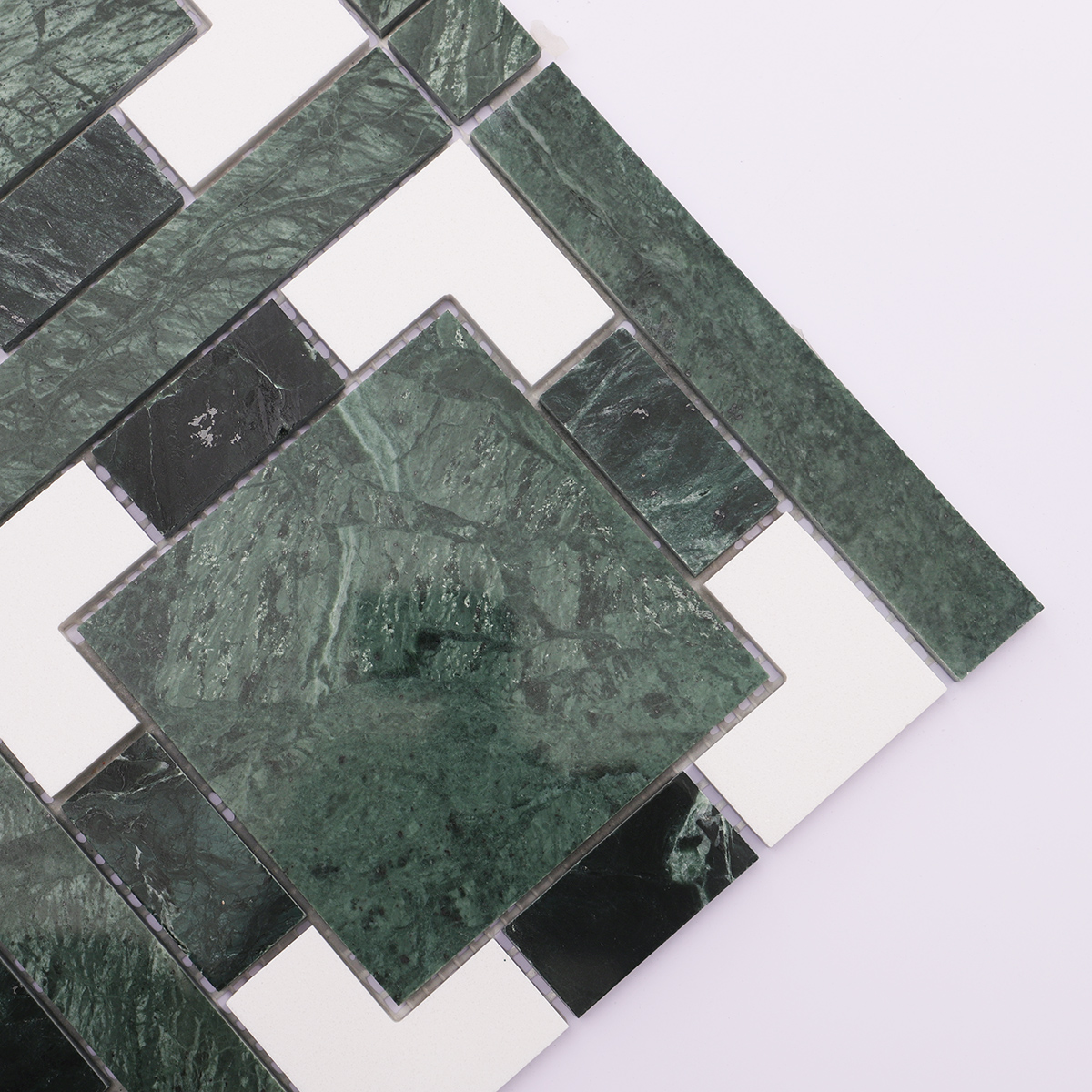 Detailed view of geometric pattern with green stone and white accents.