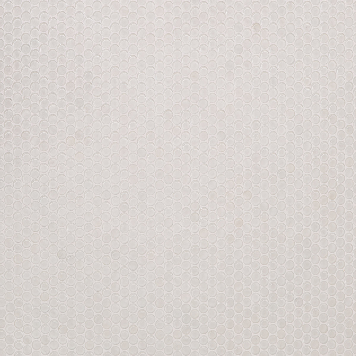 Detail view of white circular mosaic tiles after grouting