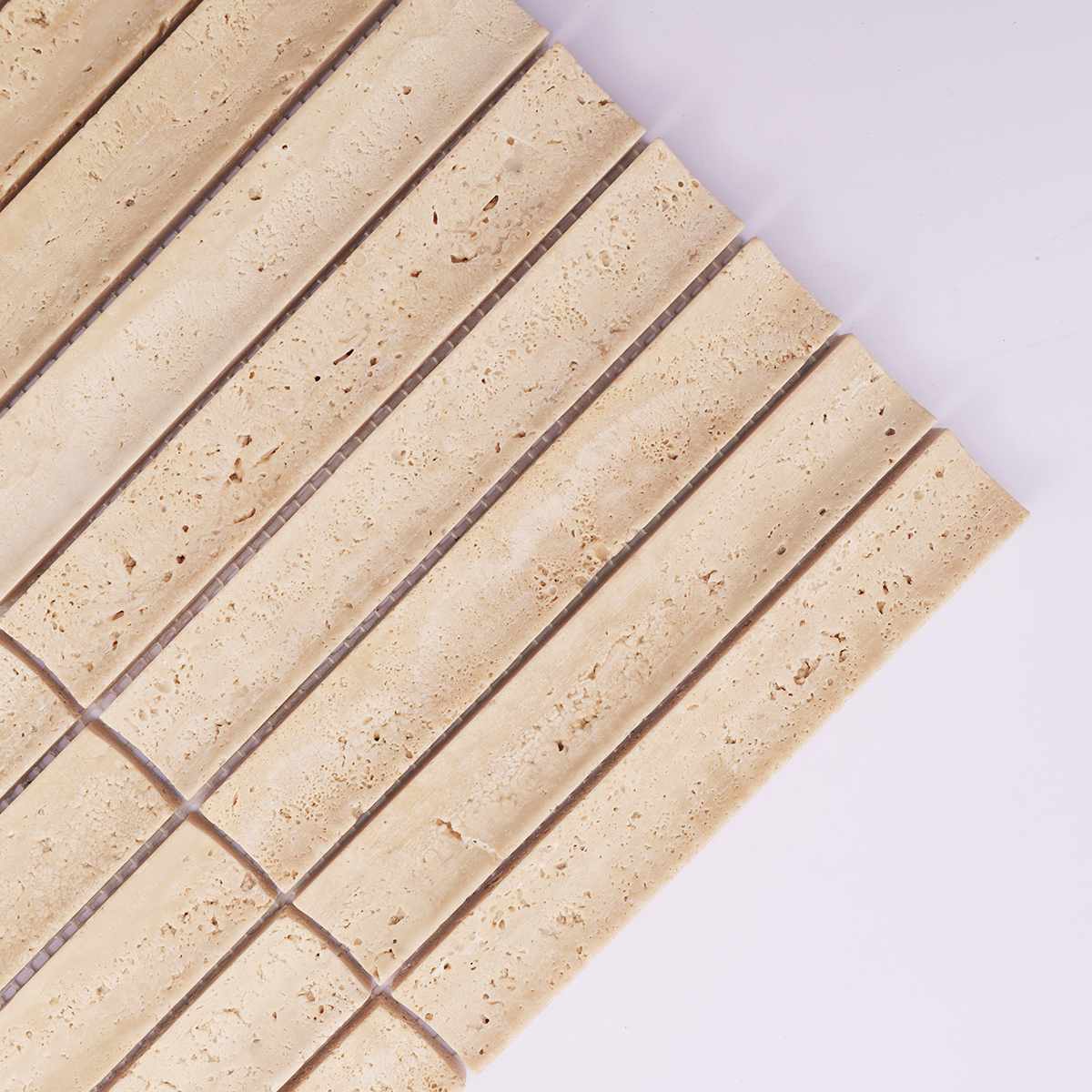 Detailed view of beige travertine mosaic tiles