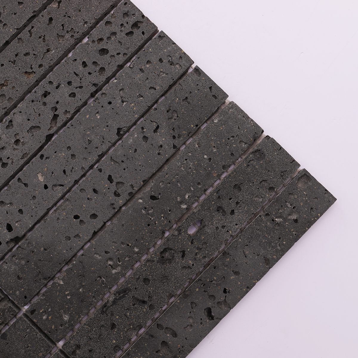 Detailed shot of the surface of the black stone mosaic tile