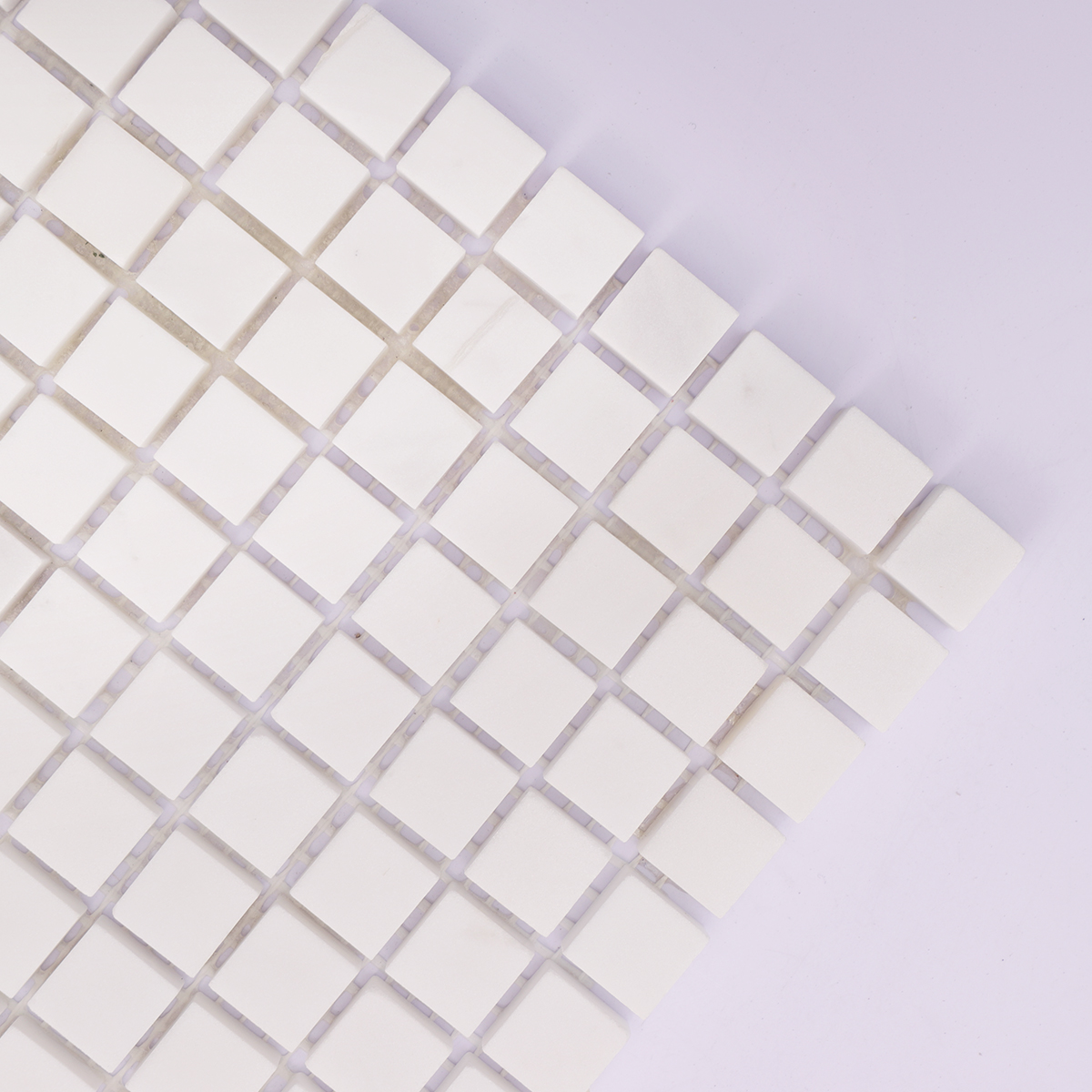 Zoomed-in image showing the smooth texture and detailing of the white marble tiles.