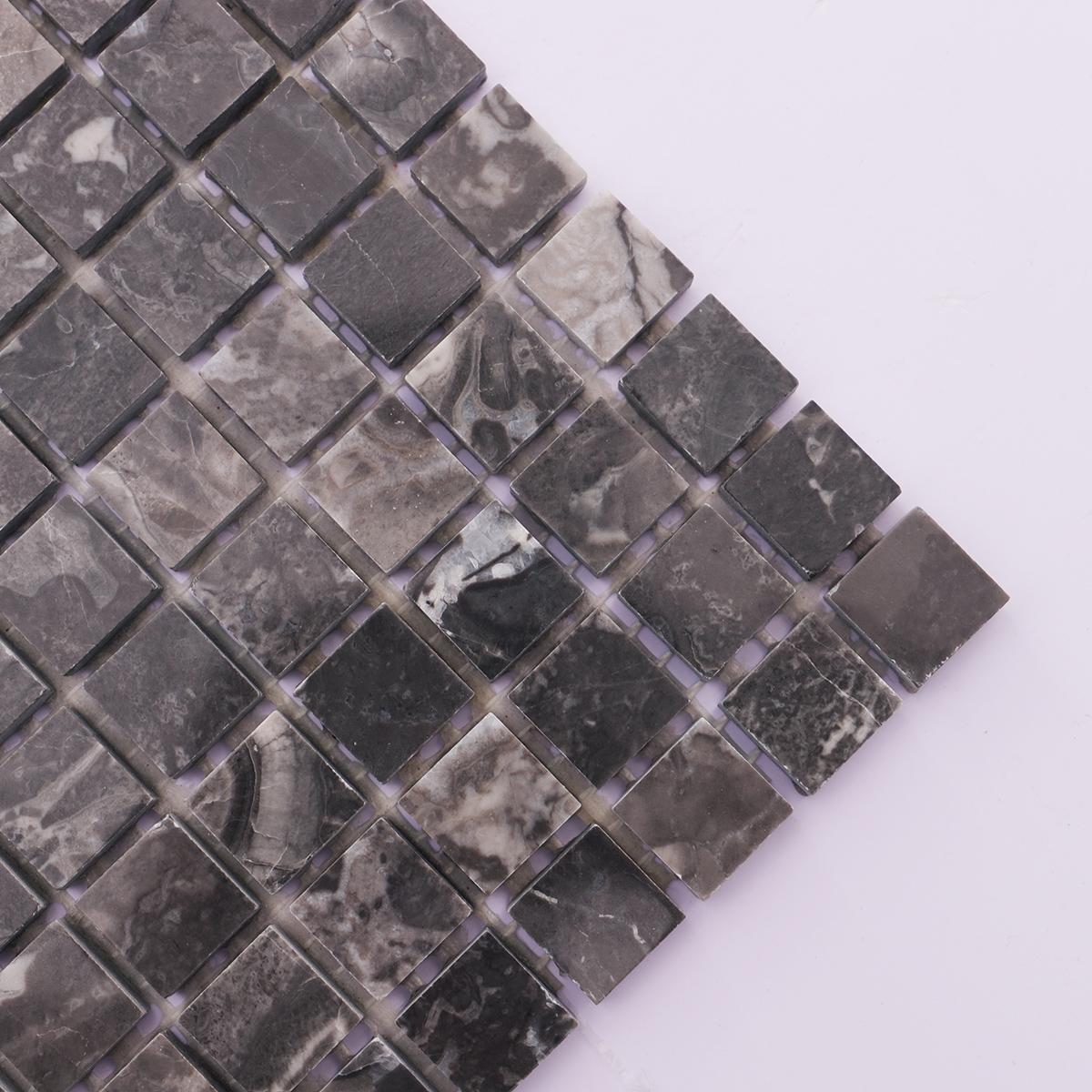 Close-up of the texture and surface of dark gray slate mosaic tiles.