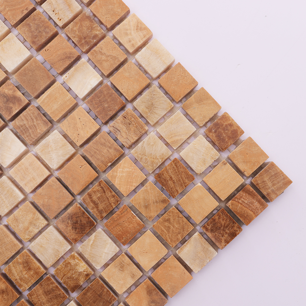 Close-up of the textured surface of light brown wooden marble mosaic tiles