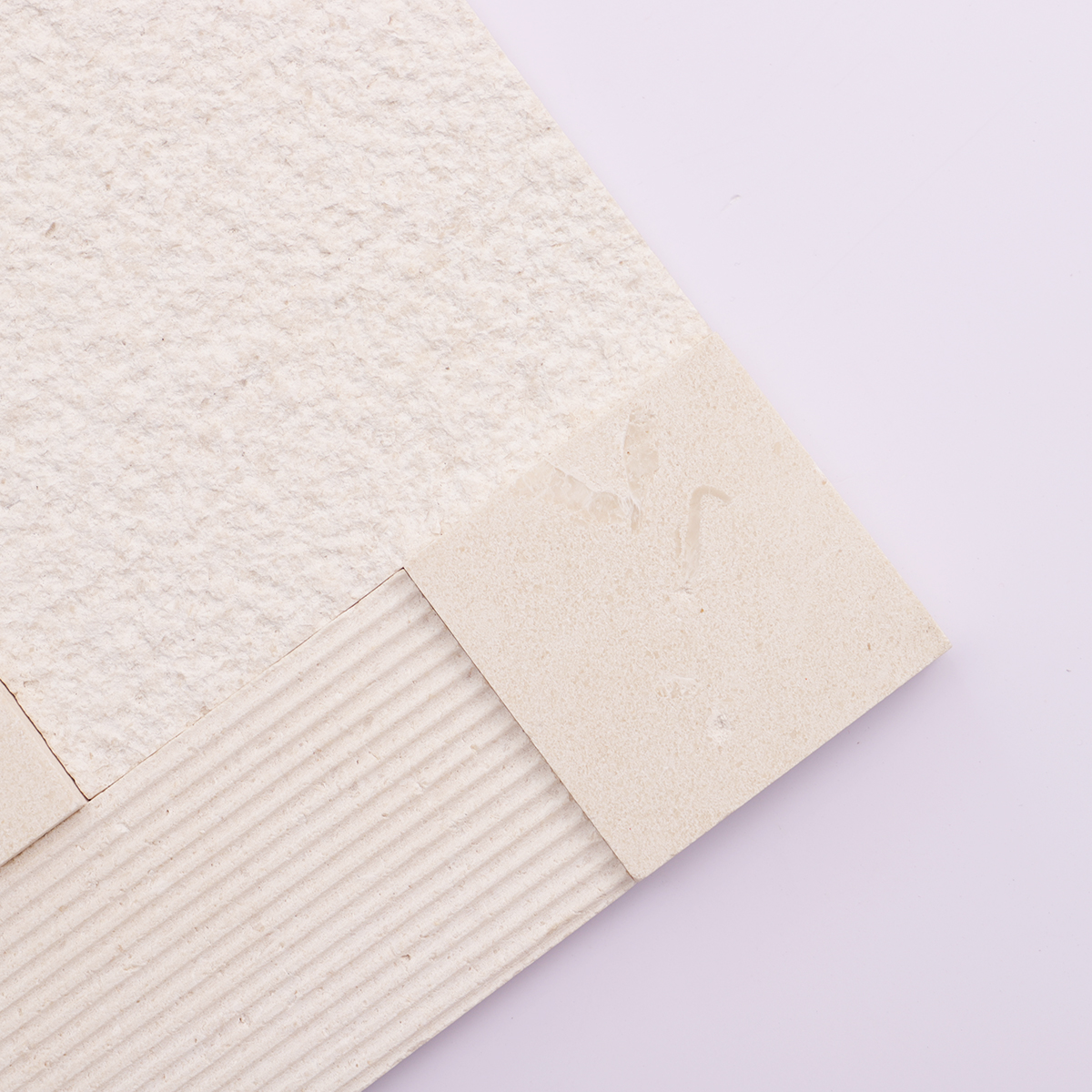 Close-up of the 3D design and texture of beige marble mosaic wall tiles