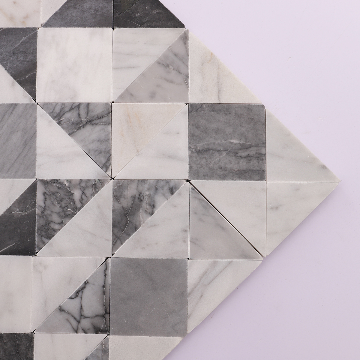 Close-up of the geometric pattern and smooth finish of the grey and white marble tiles.