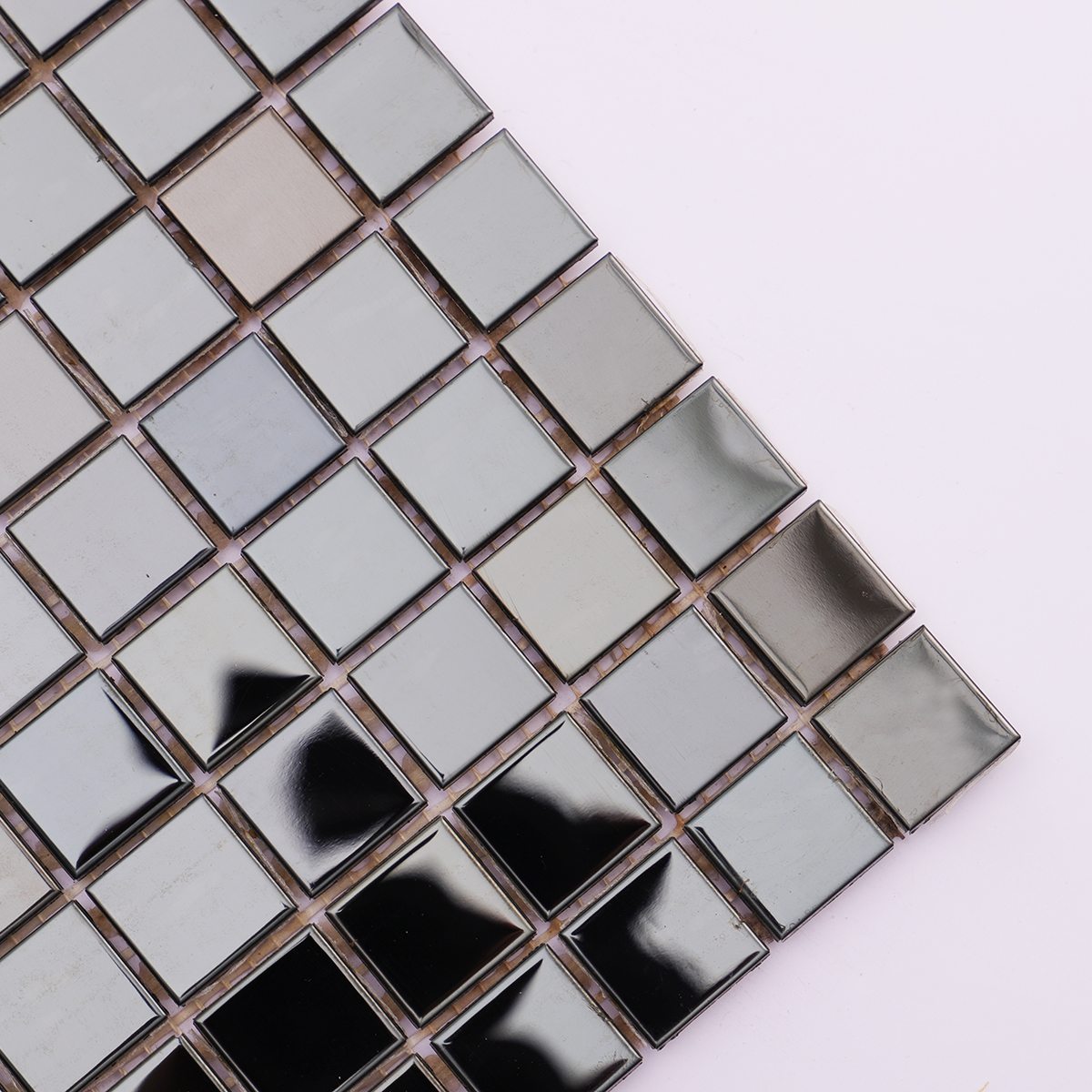 Close-up showing the reflective black mirror surface of the mosaic tiles.